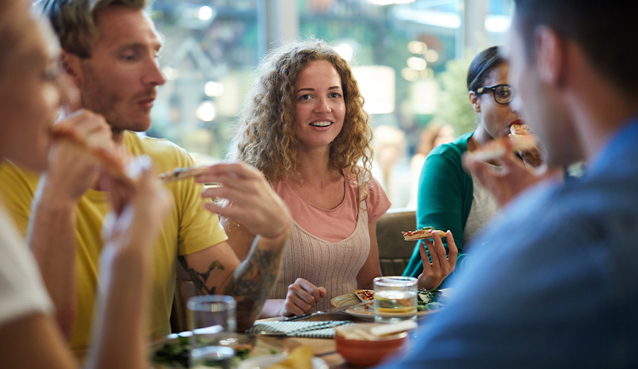 a group of people eating together at a restraunt